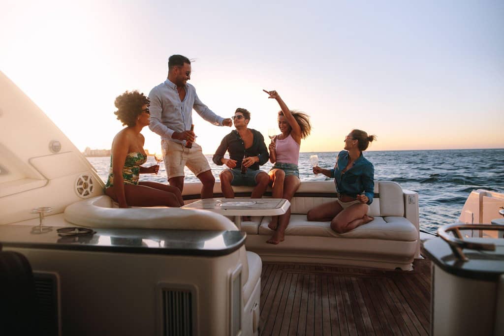 A group of friends enjoying a festive moment on a yacht at sunset off the coast of Los Cabos.